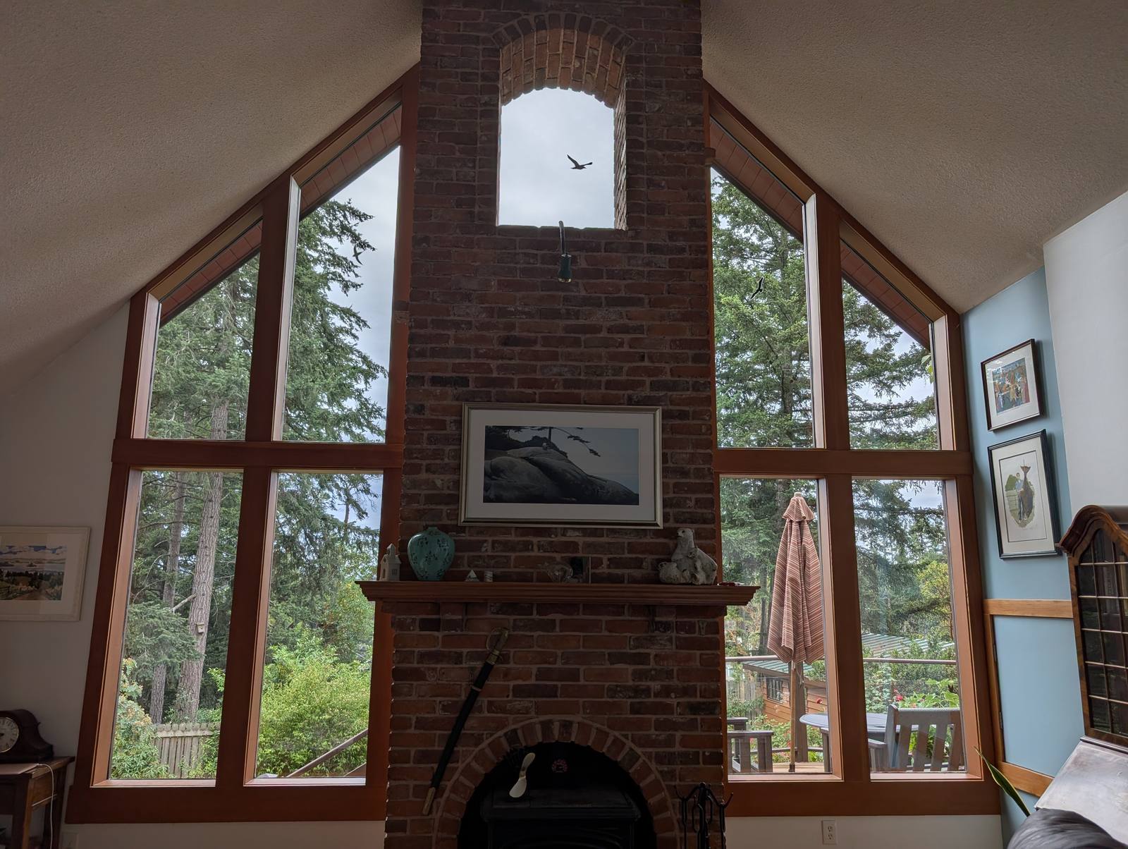 Floor to ceiling windows in an A-frame home looking out onto forest, cleaned inside and out